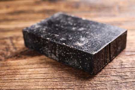 Natural tar soap on wooden table, closeupの写真素材