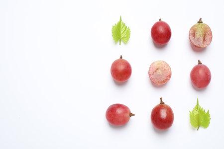 Composition with fresh ripe grapes and leaves on white background, top viewの写真素材