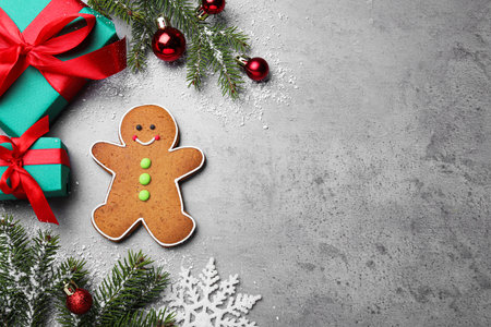 Flat lay composition with gingerbread man on gray background, space for text