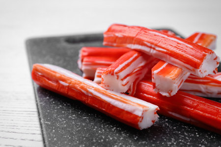 Delicious crab sticks on black board, closeupの写真素材