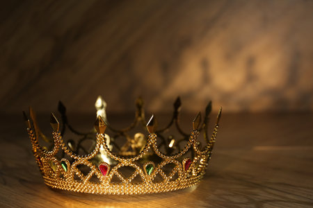 Beautiful golden crown with gems on wooden table. fantasy itemの写真素材