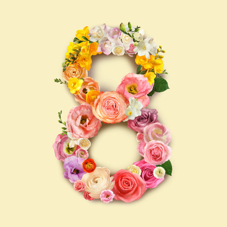 International women's day. Number 8 made of beautiful flowers on pale yellow background, top viewの写真素材