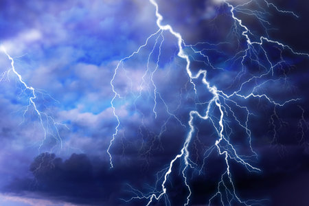 Lightnings in dark cloudy sky during thunderstorm