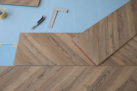 Installation of laminated wooden floor at homeの写真素材
