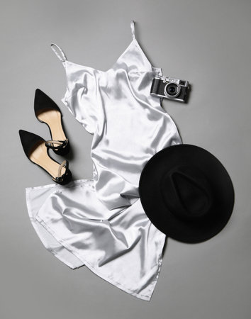 Flat lay composition with stylish white dress on gray backgroundの写真素材