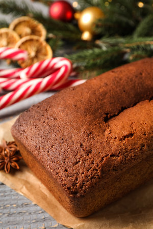 Delicious gingerbread cake and Christmas items on wooden tableの写真素材