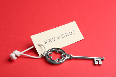 Vintage key and tag wIth word KEYWORDS on red backgroundの写真素材