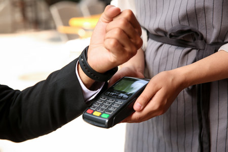 Man making payment with smart watch outdoors, closeupの写真素材