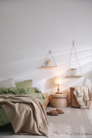 Comfortable bed with olive green linen in modern room interiorの写真素材