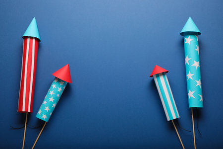 Firework rockets on blue background, flat lay with space for text. Festive decorの写真素材