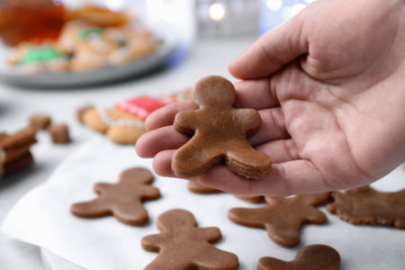 Making homemade Christmas cookies. Woman holding gingerbread man, closeupの写真素材