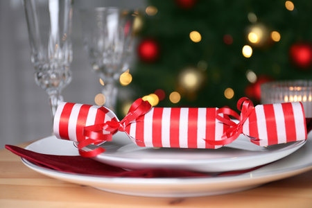 White plate with Christmas cracker on wooden table, closeupの写真素材