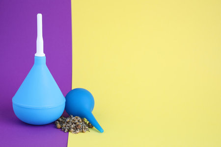 Enemas and dry chamomile on color background, space for textの写真素材