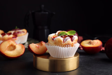 Delicious cupcakes with plums on black table, closeupの写真素材
