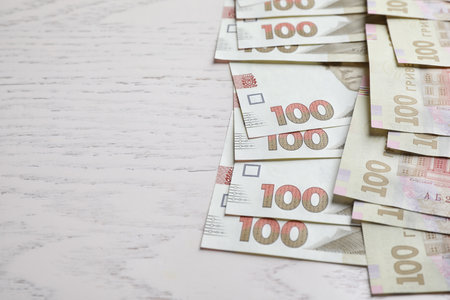 Ukrainian money on white wooden background, closeup. Space for textの写真素材