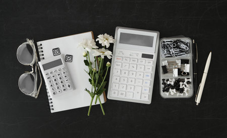 Different school stationery and beautiful white flowers on blackboard, flat lay. Happy Teacher's Dayの写真素材