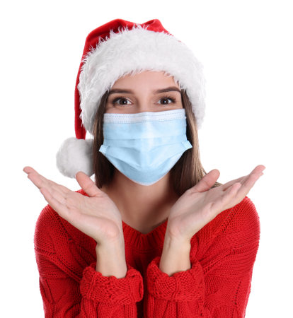 Pretty woman in Santa hat and medical mask on white backgroundの写真素材