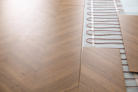 Installation of modern underfloor trace heating system indoorsの写真素材