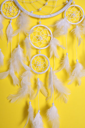 Beautiful dream catcher hanging on yellow backgroundの写真素材