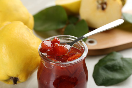Delicious quince jam on light gray table, closeupの写真素材