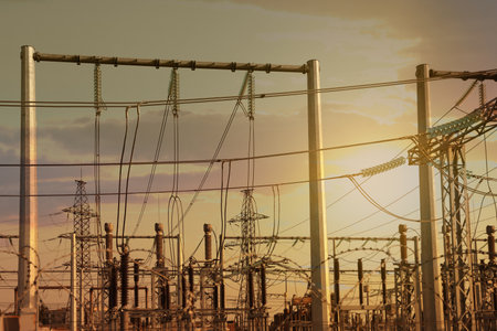 Modern electrical substation against cloudy sky at sunsetの写真素材