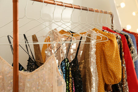 Stylish party dresses on rack indoors, closeupの写真素材