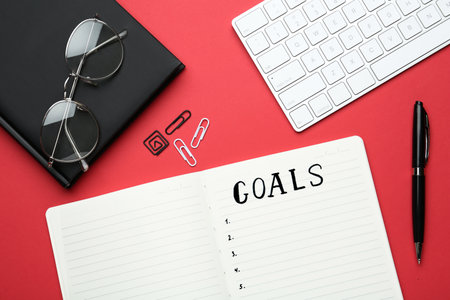 Flat lay composition with goal list on red backgroundの写真素材