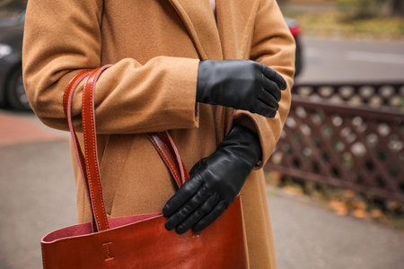 Young woman in black leather gloves, closeup. Stylish clothesの写真素材