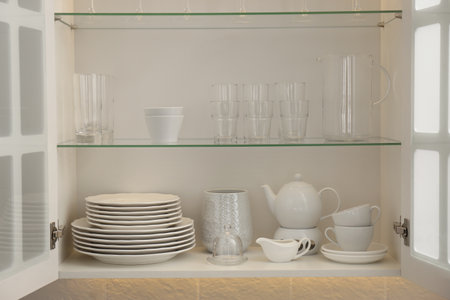 Cabinet with crockery and glassware. Order in kitchenの写真素材
