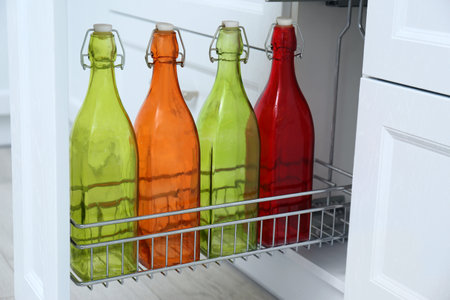 Shelf with different bottles indoors. Order in kitchenの写真素材