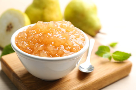 Tasty homemade pear jam and fresh fruits on wooden table, closeupの写真素材