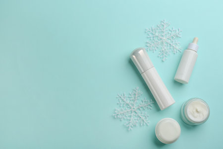 Flat lay composition with different cosmetic products on turquoise background, space for text. winter careの写真素材
