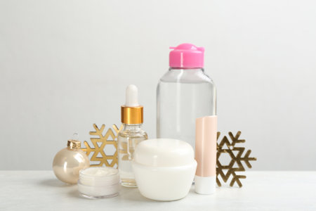 Beautiful composition with different cosmetic products on white table. winter careの写真素材