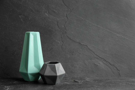 Stylish empty ceramic vases on black table, space for textの写真素材