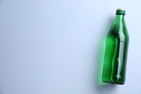 Glass bottle with water on white background, top view. Space for textの写真素材