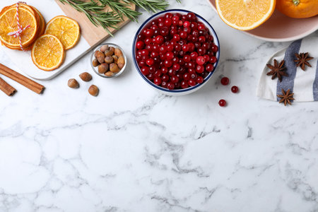 Flat lay composition with fresh ripe cranberries on white marble table. Space for textの写真素材