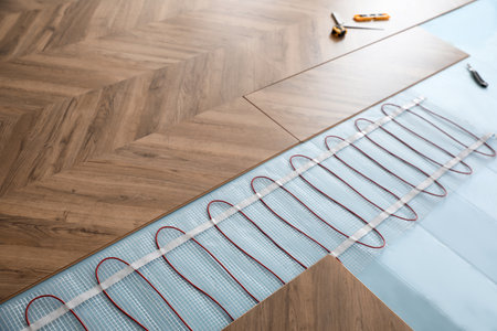 Installation of modern underfloor trace heating system indoorsの写真素材