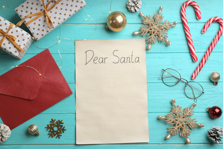 Flat lay composition with letter saying Dear Santa on turquoise wooden table, space for textの写真素材