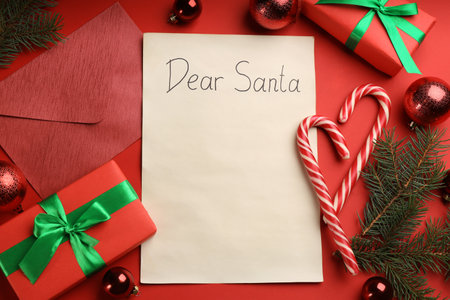 Flat lay composition with letter saying Dear Santa on red background. Space for textの写真素材