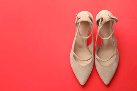 Stylish high heeled shoes on red background, top view. Space for textの写真素材