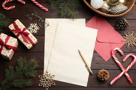 Flat lay composition with blank sheets of paper on wooden table, space for text. Writing letter to Santaの写真素材