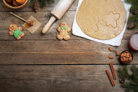 Flat lay composition with homemade gingerbread man cookies on wooden table, space for textの写真素材