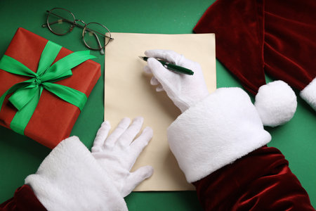 Top view of Santa writing letter at green table, closeupの写真素材
