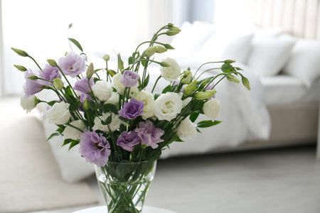 Beautiful bouquet with Eustoma flowers in bedroomの写真素材