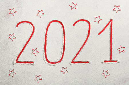2021 and stars made of flour on red background, top viewの写真素材