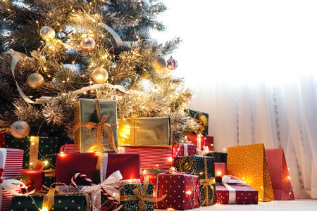 Many different gifts under Christmas tree indoorsの写真素材