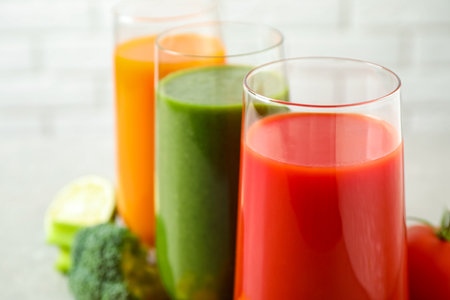 Different tasty juices in glasses, closeup. Space for textの写真素材
