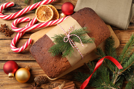 Delicious gingerbread cake, candy canes and Christmas decor on wooden table, flat layの写真素材