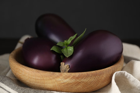 Ripe purple eggplants and basil on table, closeupの写真素材