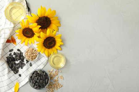 Flat lay composition with sunflower oil on gray table, space for textの写真素材